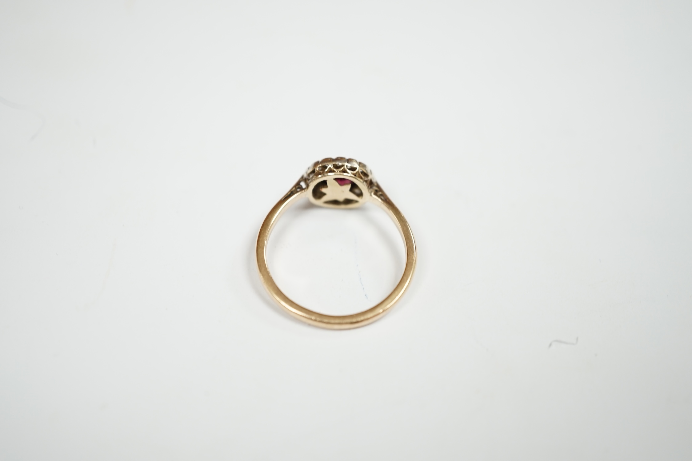 A 9ct, garnet and diamond set circular cluster ring, size R, gross weight 2.8 grams. Condition - poor